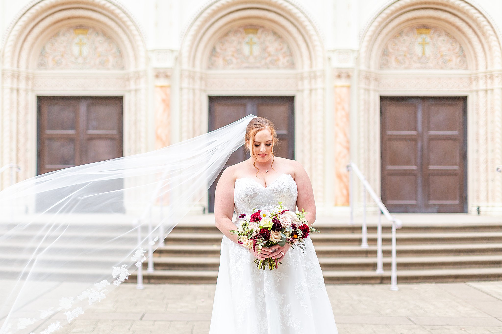 bride standing in front of church before wedding ceremony