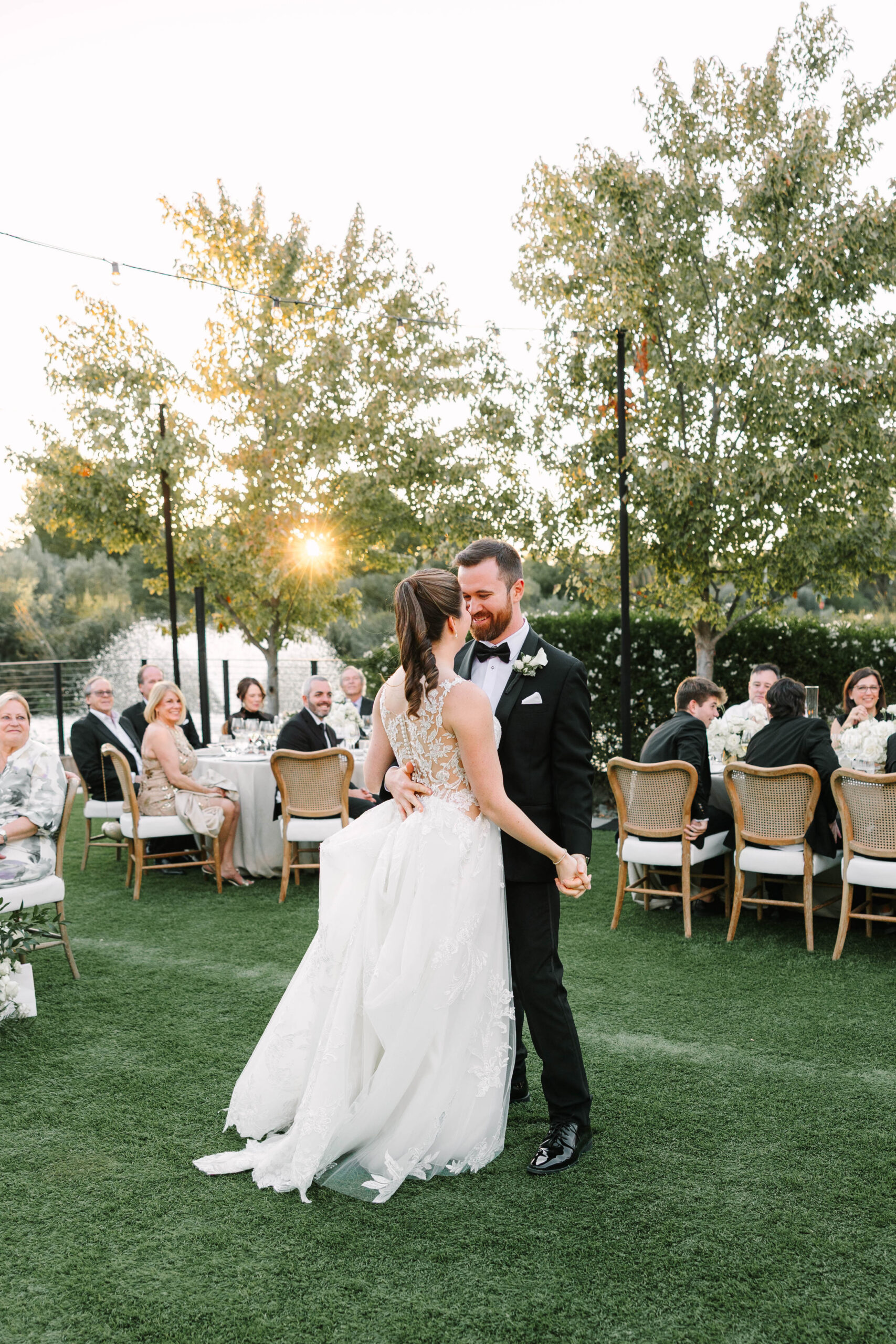 bride and groom dancing at golden hour reception at four seasons Napa valley